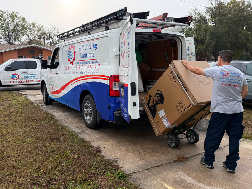 R&R service tech unloading new Lennox AC unit for installation