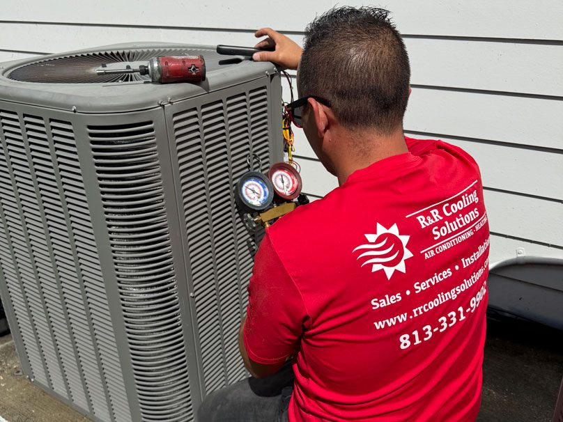 AC-Repair-2-808×606 R&R service tech repairing a residential AC unit